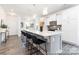 Spacious kitchen with long island, bar seating, white cabinets, and stainless steel appliances, great for entertaining at 24558 Blue Heron Cir # 402, Lancaster, SC 29720