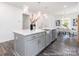 Kitchen island with gray cabinetry, stainless steel appliances, and bright lighting provides ample workspace at 24558 Blue Heron Cir # 402, Lancaster, SC 29720