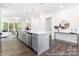 Bright, open-concept kitchen with a large island, stainless steel appliances, and seamless flow to living area at 24558 Blue Heron Cir # 402, Lancaster, SC 29720