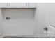 Practical laundry room with washer hookups and storage cabinets above at 24558 Blue Heron Cir # 402, Lancaster, SC 29720
