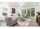 Bright living room featuring modern furnishings and a sliding glass door to the outside at 24558 Blue Heron Cir # 402, Lancaster, SC 29720