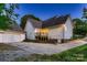 A serene backyard with lush greenery, an outdoor deck, and a detached garage at 308 Valhalla Dr, Harrisburg, NC 28075