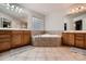 Bathroom featuring a jacuzzi tub, double vanities, and neutral tiling at 308 Valhalla Dr, Harrisburg, NC 28075