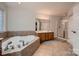 Large bathroom featuring a soaking tub, double vanity, and a separate shower at 308 Valhalla Dr, Harrisburg, NC 28075