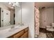 Well-lit bathroom with a large mirror, vanity, and seahorse-themed shower curtain at 308 Valhalla Dr, Harrisburg, NC 28075