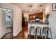 View of the eat-in kitchen area with counter seating and cherry wood cabinets at 308 Valhalla Dr, Harrisburg, NC 28075
