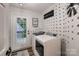 Modern laundry room with stylish decor, laundry appliances, and direct access to the outdoors at 308 Valhalla Dr, Harrisburg, NC 28075