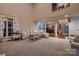 Open-concept living room with high ceilings flowing into the dining area at 308 Valhalla Dr, Harrisburg, NC 28075