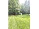 Expansive backyard with a storage shed nestled among mature trees, offering privacy and space at 317 Robert Keever Rd, Stanley, NC 28164