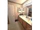 Bathroom with vanity, mirror, cabinets and patterned wallpaper at 317 Robert Keever Rd, Stanley, NC 28164