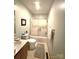 Bathroom featuring a tub with sliding glass doors, single sink vanity, and a neutral color scheme at 317 Robert Keever Rd, Stanley, NC 28164