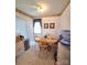 A dining area featuring a wooden table and chairs, next to a window with blinds at 317 Robert Keever Rd, Stanley, NC 28164