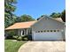 Charming single-story home with a well-maintained lawn and a spacious two-car garage at 317 Robert Keever Rd, Stanley, NC 28164