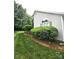 Charming exterior detail with a manicured shrubbery and a lovely, bright window at 317 Robert Keever Rd, Stanley, NC 28164