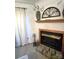 A brick fireplace decorated with art and flower arrangement at 317 Robert Keever Rd, Stanley, NC 28164