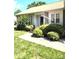 Landscaped front yard with mature shrubs and sidewalk leading to front door, with flag at 317 Robert Keever Rd, Stanley, NC 28164