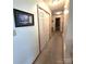A hallway with white walls, carpet flooring, and white closet doors at 317 Robert Keever Rd, Stanley, NC 28164