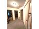 A hallway with white doors, carpet flooring, and neutral paint at 317 Robert Keever Rd, Stanley, NC 28164