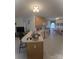 Open kitchen with an island and seating overlooking a dining area with lots of natural light at 317 Robert Keever Rd, Stanley, NC 28164