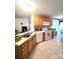 Bright kitchen featuring tile floors, ample cabinet space, and modern appliances at 317 Robert Keever Rd, Stanley, NC 28164