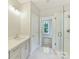 Bright bathroom features white cabinets, shower, marble floors and modern lighting at 3308 Watkins Rd, Monroe, NC 28110