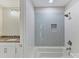 Stylish bathroom featuring a shower-tub combination, sleek tile, and a modern vanity at 3308 Watkins Rd, Monroe, NC 28110