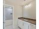 Bathroom offers modern vanity with elegant stone countertop, a soaking tub, and beautiful tile at 3308 Watkins Rd, Monroe, NC 28110