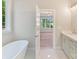 Luxurious ensuite bathroom with free-standing tub and access to the primary bedroom at 3308 Watkins Rd, Monroe, NC 28110