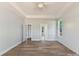Spacious primary bedroom with tray ceilings, fan, large window and ensuite bathroom at 3308 Watkins Rd, Monroe, NC 28110