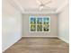 Bright bedroom features tray ceiling, fan, shiplap accent wall and large window at 3308 Watkins Rd, Monroe, NC 28110