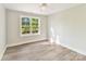 Bedroom features include neutral color palette, a window that streams in natural light, and wood-style flooring at 3308 Watkins Rd, Monroe, NC 28110