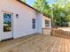 Back deck with a wooden railing, door to the house, and views of the trees at 3308 Watkins Rd, Monroe, NC 28110