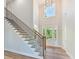 Bright entryway boasts soaring ceilings, wood floors, staircase, and glass front door that streams natural light at 3308 Watkins Rd, Monroe, NC 28110