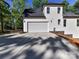 Home exterior showcasing the garage, driveway, and lush surrounding landscape at 3308 Watkins Rd, Monroe, NC 28110