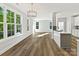 Open-concept kitchen and living area with a kitchen island and large windows providing natural light at 3308 Watkins Rd, Monroe, NC 28110