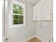 Bright laundry room with a window, cabinetry, and washer/dryer hookups at 3308 Watkins Rd, Monroe, NC 28110
