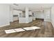 Open-concept living area with hardwood floors connecting the kitchen and living spaces at 3308 Watkins Rd, Monroe, NC 28110