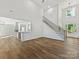 Spacious living room features hardwood floors, soaring ceilings, and an adjacent staircase at 3308 Watkins Rd, Monroe, NC 28110