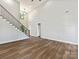 Spacious living room with hardwood floors, high ceilings, staircase and natural light from large window at 3308 Watkins Rd, Monroe, NC 28110