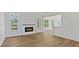 Bright living room features hardwood floors, fireplace, windows and access to the outdoor living space at 3308 Watkins Rd, Monroe, NC 28110