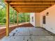Exterior of home with concrete patio and a view of the lush tree line at 3308 Watkins Rd, Monroe, NC 28110