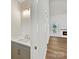 Well-lit powder room showcases modern fixtures, vanity with sink, and access to a living room with a fireplace at 3308 Watkins Rd, Monroe, NC 28110