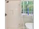 Modern bathroom features shower with glass enclosure, white tile and river rock floor at 3308 Watkins Rd, Monroe, NC 28110