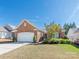 Charming one story brick home with a two car garage and well manicured landscaping at 43014 Mimosa Ct, Indian Land, SC 29707