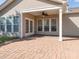 Covered back patio with brick pavers and ceiling fan offers a relaxing outdoor space at 43014 Mimosa Ct, Indian Land, SC 29707