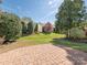 Well-maintained backyard features a brick patio and lush landscaping at 43014 Mimosa Ct, Indian Land, SC 29707