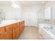 Spacious bathroom with double sink vanity, soaking tub, and separate glass shower at 43014 Mimosa Ct, Indian Land, SC 29707