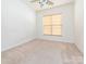 This bedroom has a ceiling fan and a window to provide plenty of light at 43014 Mimosa Ct, Indian Land, SC 29707