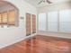 Inviting dining area with hardwood floors and natural light from a double door and large windows at 43014 Mimosa Ct, Indian Land, SC 29707