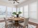Bright dining room features large windows, natural light and a stylish modern table with seating for four at 43014 Mimosa Ct, Indian Land, SC 29707